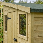 Close-up of the pressure-treated shiplap cladding and window of the Elmstead shed