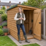 Woman putting a spade into the open Larkfield 6x4 pent shed