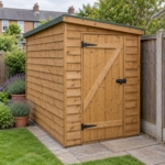 Larkfield 6x4 overlap pent garden shed against a fence in a small garden