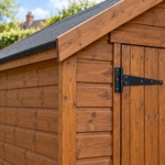 Close-up of the heavy T-hinge, cladding and corner trim of the Wexcombe shed